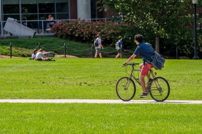 Student riding his bicycle accross the Student Union Mall 